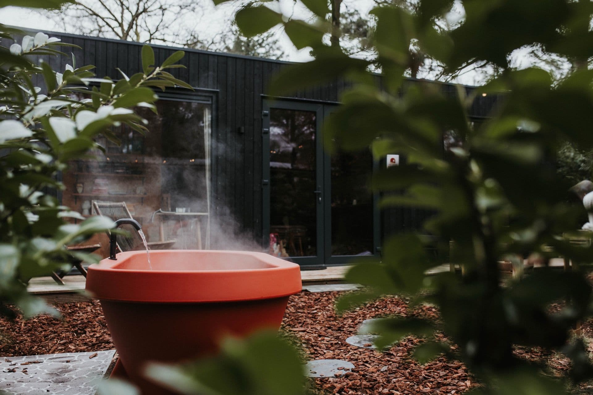 Private outdoor hot tub in secluded garden at Tiny House MIYO Nunspeet Veluwe